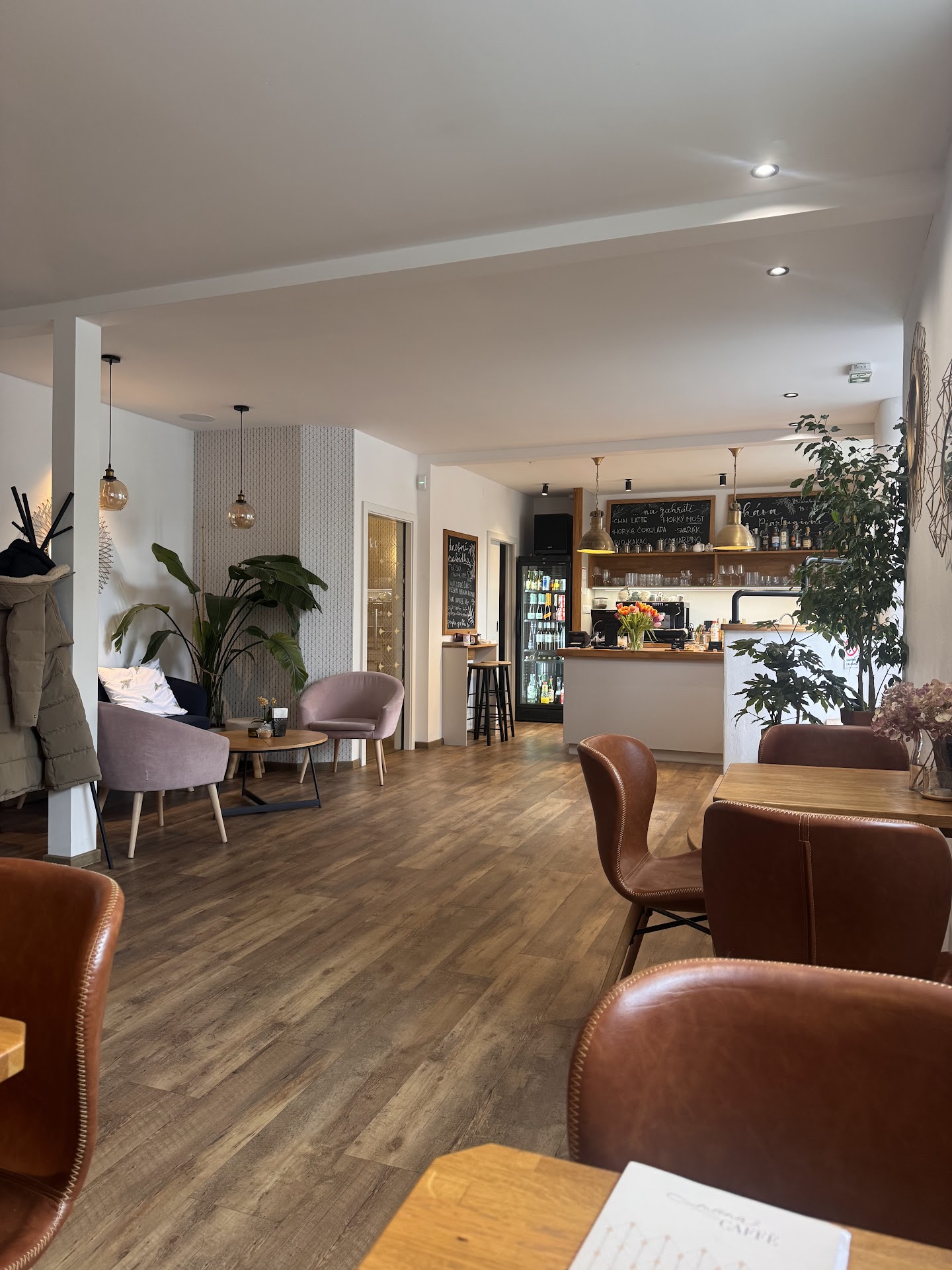Interiér Mana Caffè s barem a růžovými křesílky